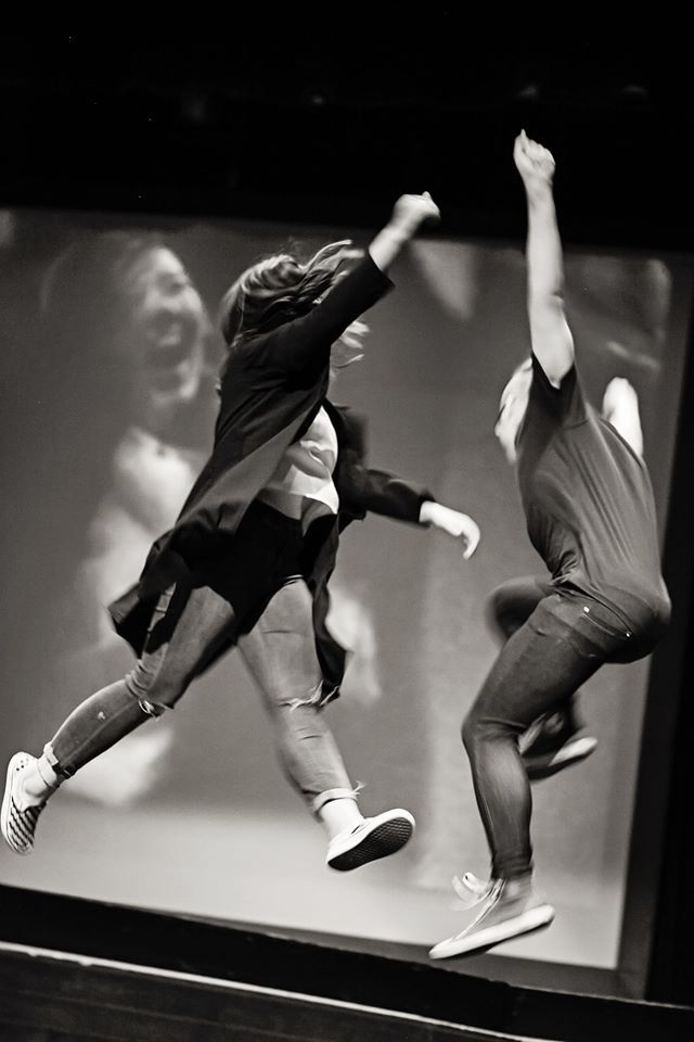 Two students who participated in the event ump in the air while giving each other high-fives. The OC RYSE has created a safe environment for students to express their emotions through the use of poetry.