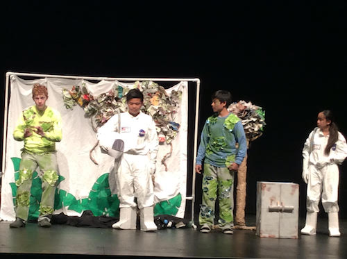 Laguna Beach Code Breakers, from left to right: Kyle Herkins, Andrew Duong, Kenneth Chu, and Isabel Duong perform original skit in Tennessee for Destination Imagination Global Finals tournament. They acted in front of a panel of judges and audience for eight minutes.



