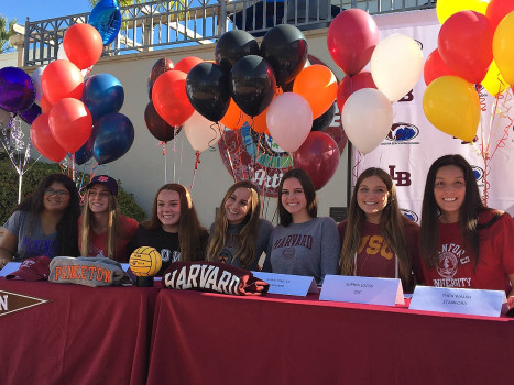 (Left to right) Danielle Borelli, Kyla Whitelock, Isabel Riches, Alana Evans, Evan Tingler, Sophia Lucas, and Thea Walsh sign to their colleges in the quad on signing day. They have broken a school record for the most seniors from a single team to sign to colleges.