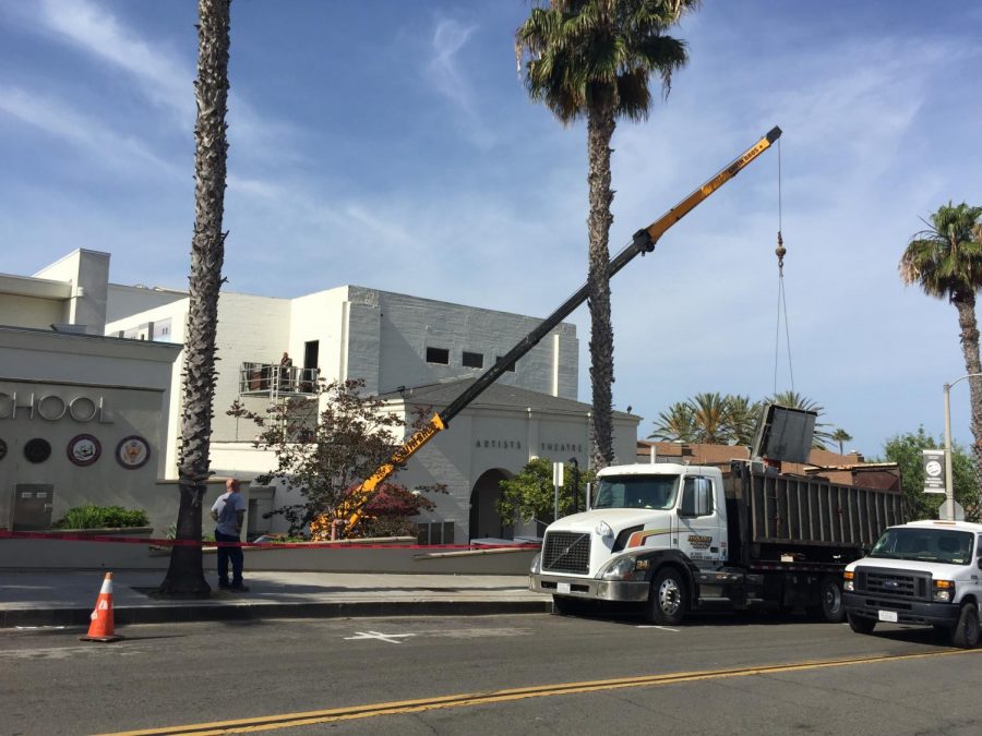 Construction crews use crane to place AC units on the theatre roof.