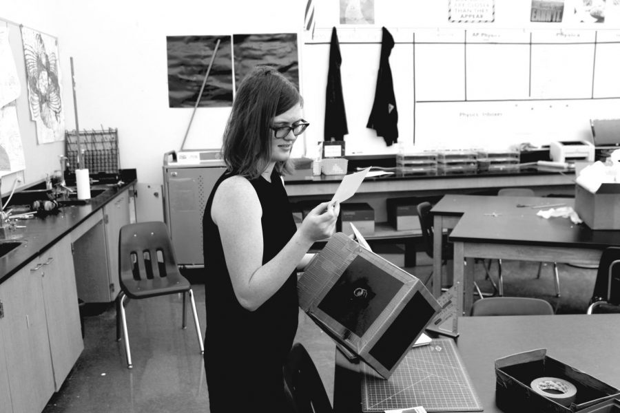 Senior+Chloe+Flanagan+examines+a+photograph+taken+by+a+camera+that+she+made+in+engineering+class.+Students+learned+about+exposure+and+how+to+develop+photographs.