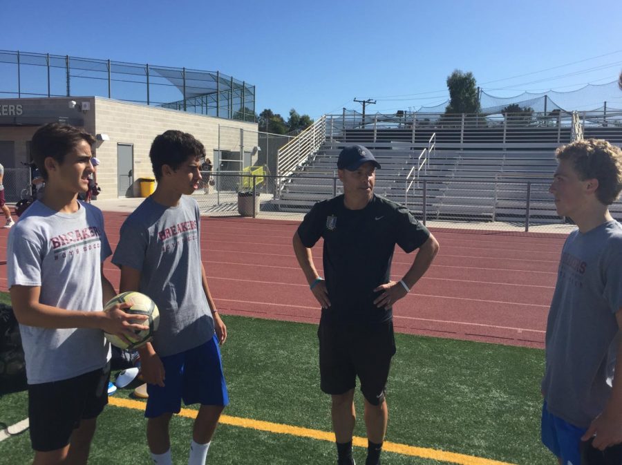  Thomas (center) talks to his players (from left to right) Adrian Ricci-Fisher, Diego Tellez Rodriquez and Griffin Kristensen about the upcoming season. Coach Thomas has found success with the team in the past and looks to continue that success with his new players.