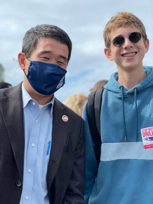 Parker Forgash (right) takes a photo with California Senator (left) at the rally at Main Beach. 