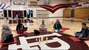 Students sit and meditate in a large circle around the Dugger Gym floor at LBHS. These yoga classes are taught by Staci Bina.