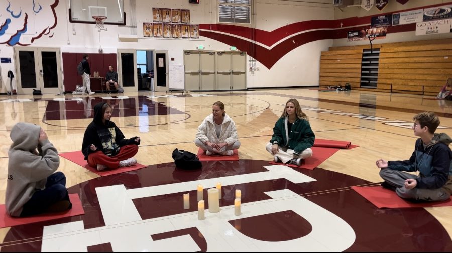 Students sit and meditate in a large circle around the Dugger Gym floor at LBHS. These yoga classes are taught by Staci Bina.