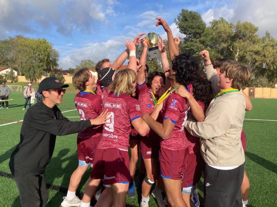 Euan Latimer hoists the SoCal Rugby 7s title as the team surrounds him. The Breakers defeated St. Anthony 29-12.