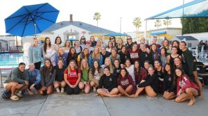 Laguna Beach High School girls water polo students and staff pose for a picture with alumni. The 2022-2023 season ended with a 19-10 overall record.