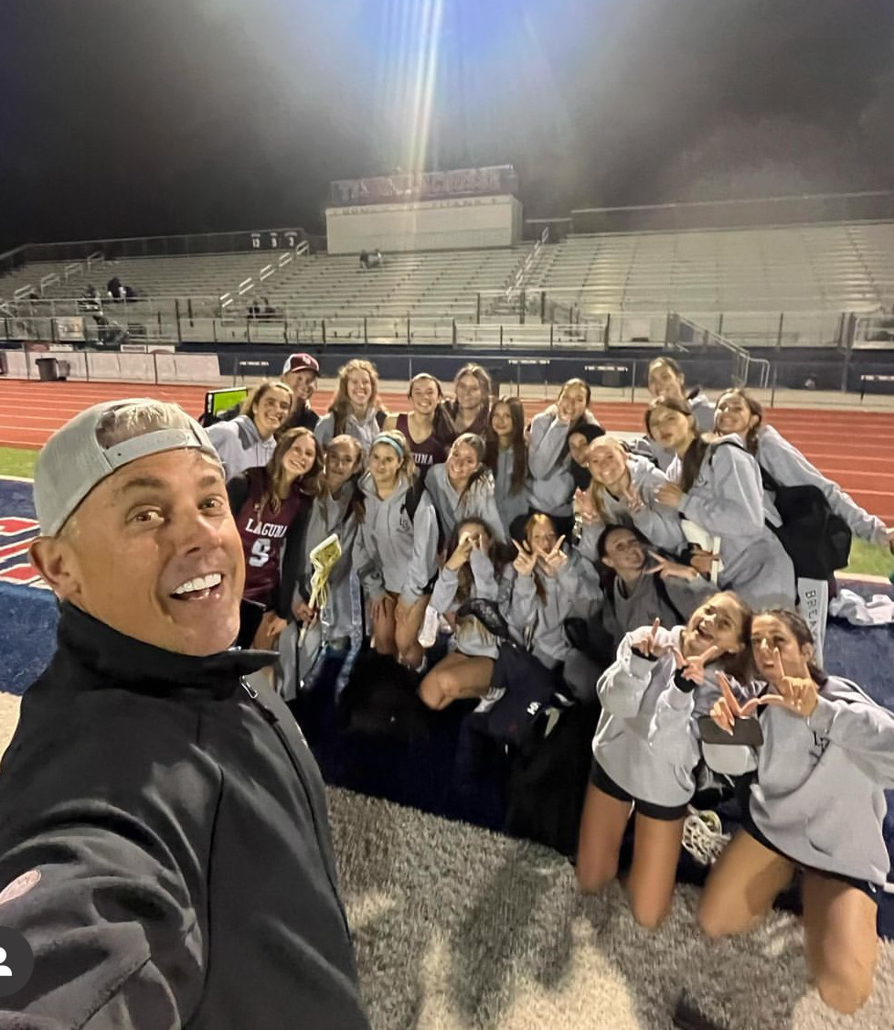 The+LBHS+Girls+Lacrosse+team+and+coach+pose+for+a+post+game+photo.+On+February+13th%2C+the+varsity+team+carried+a+16-2+win+against+Irvine+High+School.+