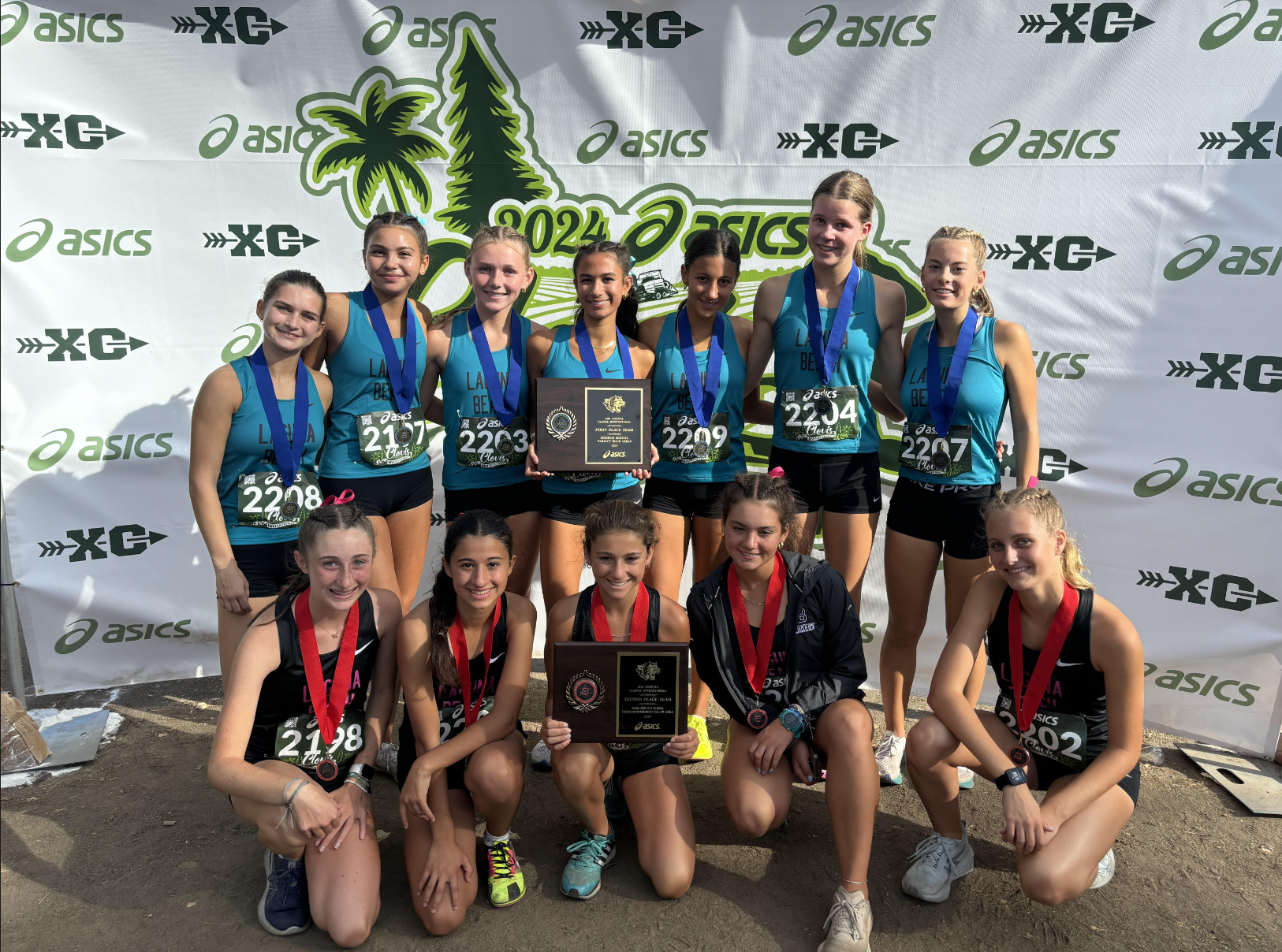 The Varsity (blue) and JV (black) girls taking a celebratory photo after winning 1st and 2nd at the Clovis Invitational. 