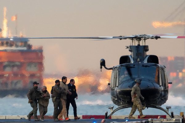DEA (Drug Enforcement Administration) agents move captured Venezuelan President Nicolas Maduro and his wife Cilia Flores out of the helicopter, as Maduro heads towards the Daniel Patrick Manhattan United States Courthouse for an initial appearance to face U.S. federal charges including narco-terrorism, conspiracy, drug trafficking, money laundering and others in New York City, U.S., January 5, 2026. REUTERS/Adam Gray
